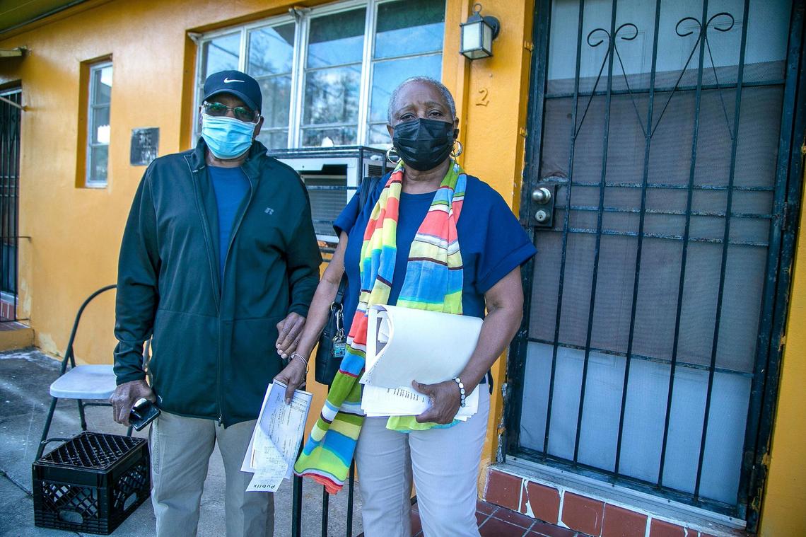 Linda Mallard and her father, John Palmer, stand in front of an apartment in a building they own in the Little River neighborhood of Miami on Jan. 19, 2021. They hired an eviction company to boot out the tenant living at that apartment, who stopped paying rent in February 2020.
