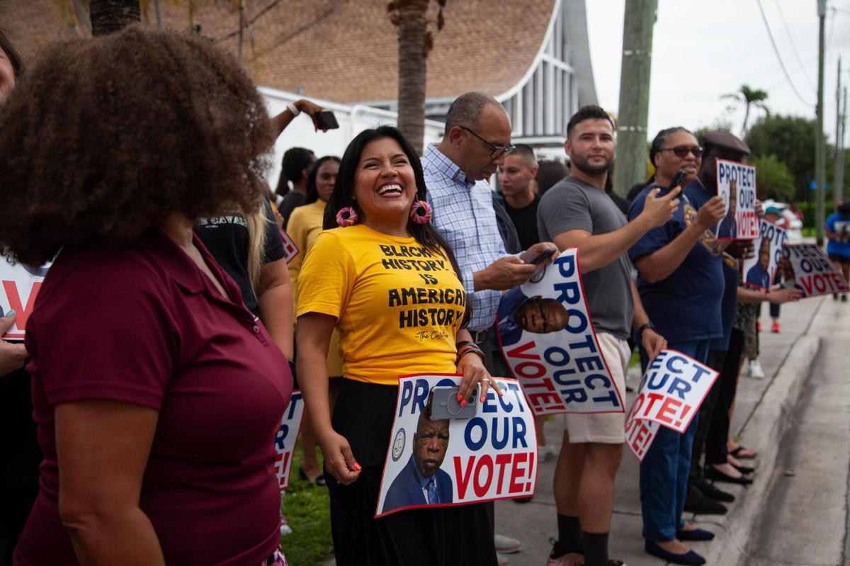 Karla Hernandez Mats, United Teachers of Dade president, smiles as the Stay Woke Florida bus tour arrives at Mt. Olive Missionary Baptist Church on June 22, 2023, in South Miami, Florida.