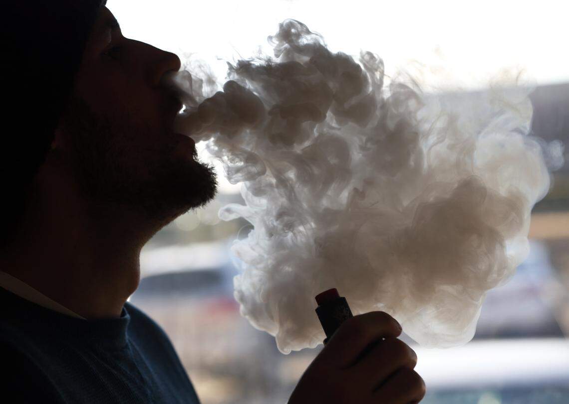 A cloud of smoke from a vape pipe at a local vape shop in Richmond, Virginia., Friday, Jan. 18, 2019. Tobacco-friendly Virginia is preparing to raise the age limit on buying traditional and electric cigarettes from 18 to 21.