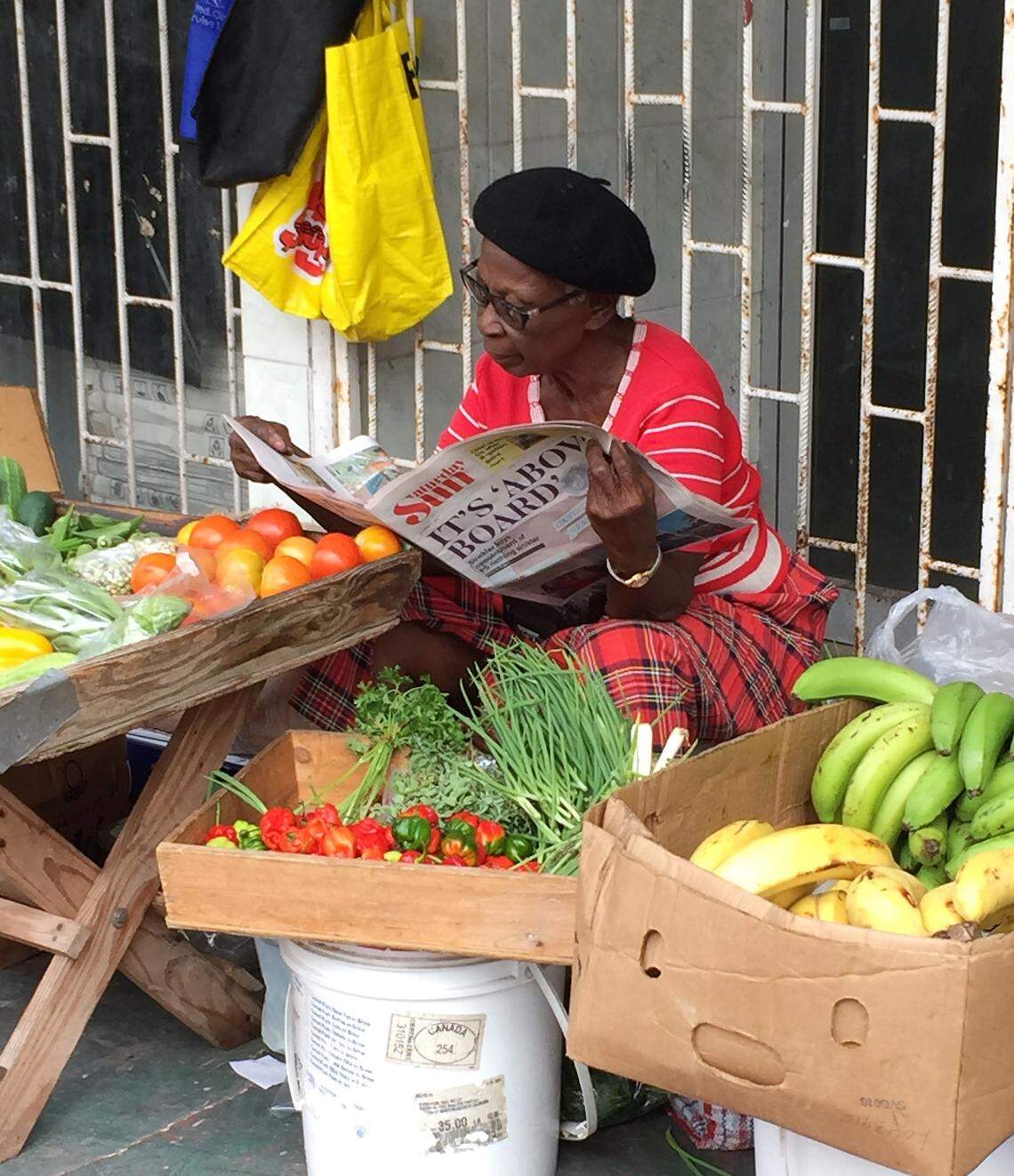 Quiet sidewalk seller of fruit and vegetables in downtown Bridgetown, Barbados.