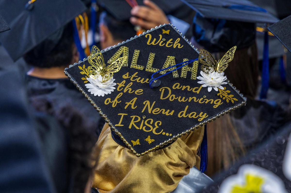 Messages on graduating students’ mortarboards during Miami Dade College’s North, Hialeah and West Campuses 2025 commencement ceremonies at LoanDepot Park, in Miami on Saturday, April 26, 2025.