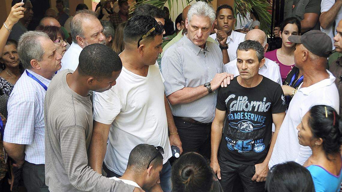 Cuba's President Miguel Diaz-Canel, center, visits with family members of passengers who perished in a Boeing 737 that plummeted into a farm field shortly after taking off from the airport in Havana, Cuba. Diaz-Canel has set a whirlwind pace of public appearances since his first day in office, promising improvement in trash pickup and public transportation, inspecting state cafeterias and health clinics, and now acting as the public face of the government's response to the May 18 air crash.