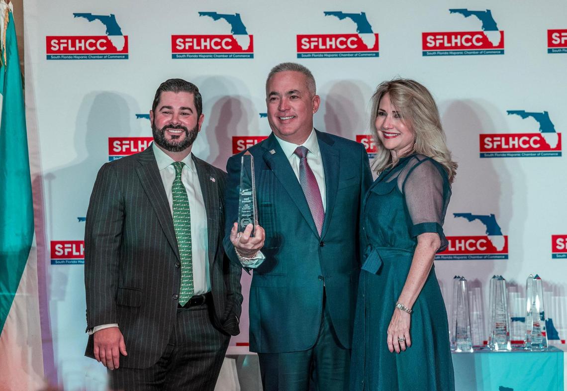 Iván Herrera, Founder/ CEO of UniVista Insurance, displays his SFLHCC Elite Business Icon Award, flanked by Alejandro Mendieta, SFLHCC Secretary and Liliam M. Lopez, President/CEO SFLHCC, during the South Florida Hispanic Chamber of Commerce’s ‘Hispanic Leadership Awards” lunch at the Biltmore Hotel in Coral Gables, on Friday March 14, 2025.