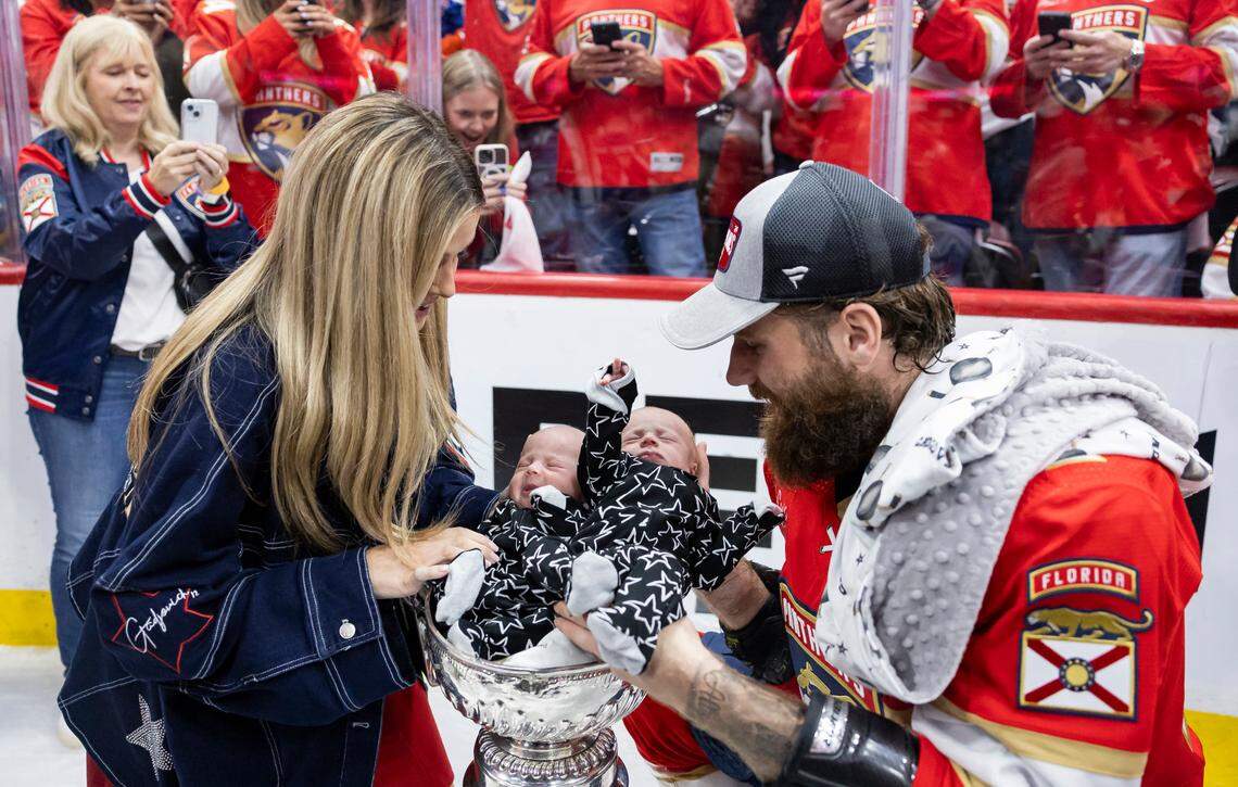 Florida Panthers left wing Jonah Gadjovich (12) with his wife, Allison, place their one-month-old twins, Lion and Adalee, in the Stanley Cup after defeating the Edmonton Oilers in Game 7 of the Stanley Cup Final at Amerant Bank Arena on Monday, June 24, 2024, in Sunrise, Fla.