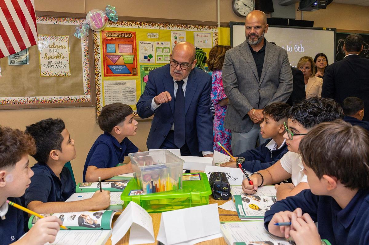 Superintendent of Miami-Dade County Public Schools Jose L. Dotres speaks to students about their schedules during the first day of school at Hialeah Middle School.