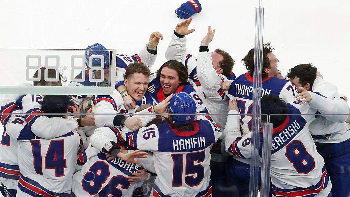 MILAN, ITALY - FEBRUARY 22: Jack Hughes #86 of Team United States celebrates with teammates after scoring the game-winning goal to win the gold medal in overtime during the Men's Gold Medal match between Canada and the United States on day 16 of the Milano Cortina 2026 Winter Olympic games at Milano Santagiulia Ice Hockey Arena on February 22, 2026 in Milan, Italy. (Photo by Jamie Squire/Getty Images)