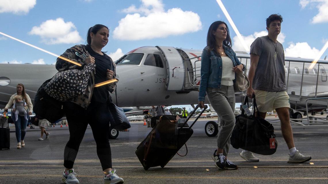 Private flyers walk along the tarmac at JSX Terminal in Miami, Florida, on Friday, April 21, 2023.