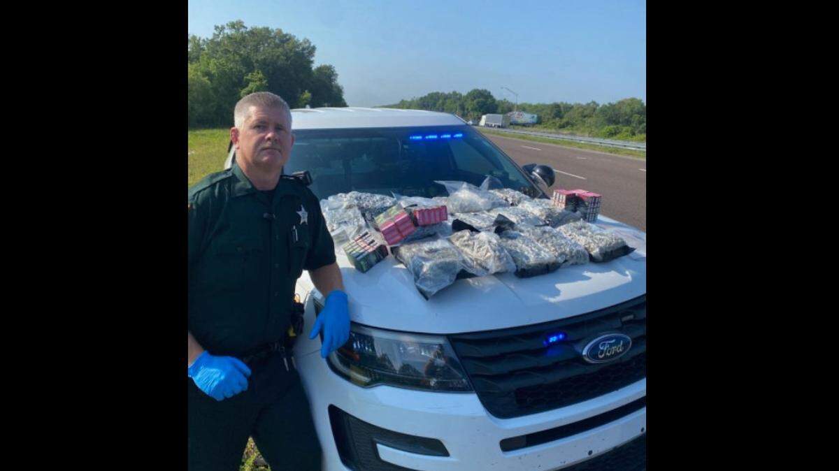 Deputy Jason Lewis of the Osceola County Sheriff’s Office poses with drugs from a stop on I-95
