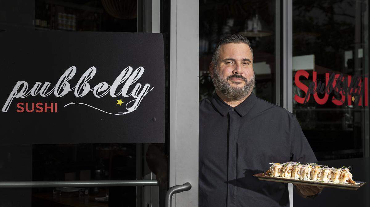 Chef Jose Mendin holds a Acevichado Roll at his restaurant, Pubbelly Sushi, on Thursday, Sept. 18, 2025, in Miami Beach, Fla. Mendin, who is Puerto Rican, is celebrating the restaurant's 15th anniversary. The roll consists of lobster, crab, shrimp, soy paper, leche de tigre, red onion, cancha corn, mango and tomato.