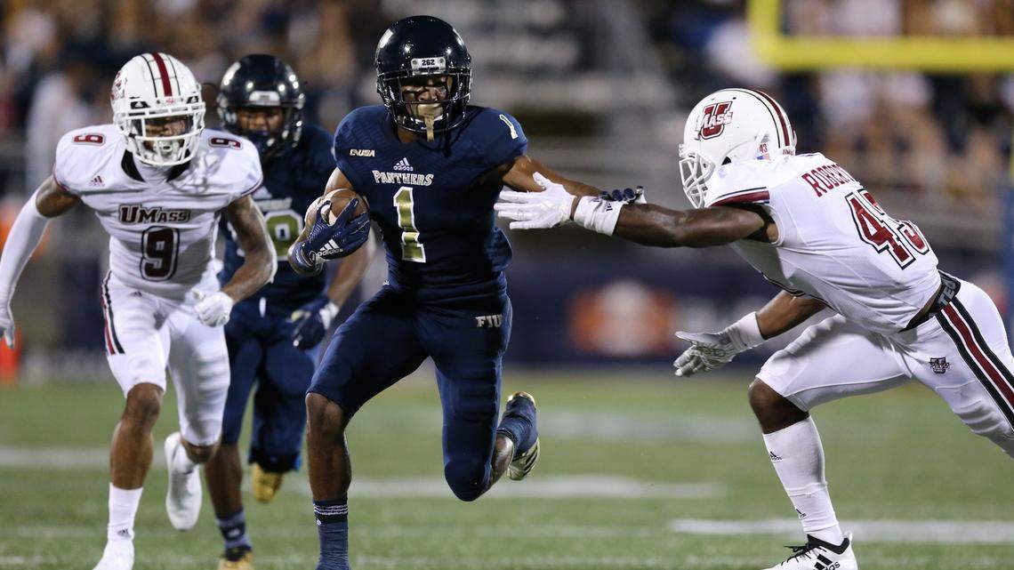 FIU wide receiver Maurice Alexander (1) runs for a touchdown in the second quarter as Massachusetts Minutemen cornerback Brian Roberts Jr. (43) on Sept. 15.