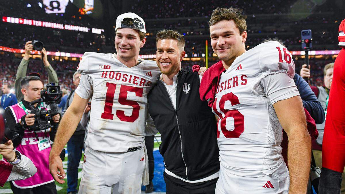 INDIANAPOLIS, INDIANA - DECEMBER 06: Brothers Fernando Mendoza #15 (L) and Alberto Mendoza #16 (R) of the Indiana Hoosiers pose for a photo after the Big Ten Championship game against the Ohio State Buckeyes at Lucas Oil Stadium on December 06, 2025 in Indianapolis, Indiana. The Indiana Hoosiers won the game 13-10. (Photo by Aaron J. Thornton/Getty Images)