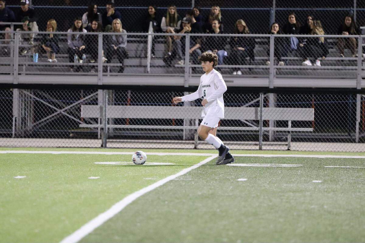 Westminster Christian soccer player Markus Ruiz leads the team in prayer after a game last season. Ruiz lost his father to cancer and his mother is a breast cancer survivor. He will honor both by playing in a charity tournament in Vero Beach this January.
