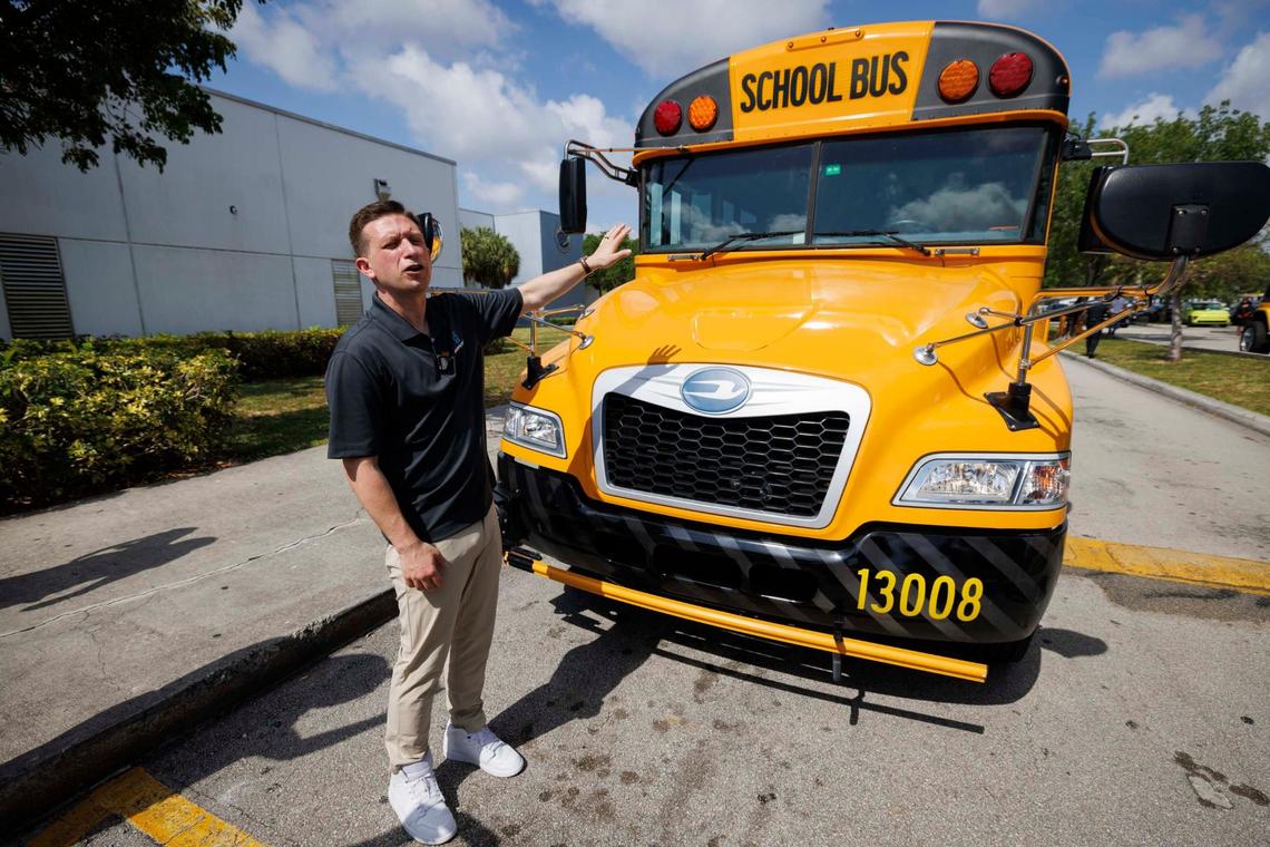 Steve Randazzo, chief growth officer for BusPatrol, points to the bus after a press conference announcing a new bus stop-arm camera enforcement program to fine drivers who don’t stop at school buses when the stop sign is out on Tuesday, May 7, 2024, at Dr. Michael M. Krop Senior High School. The program started enforcing the fines on May 8.