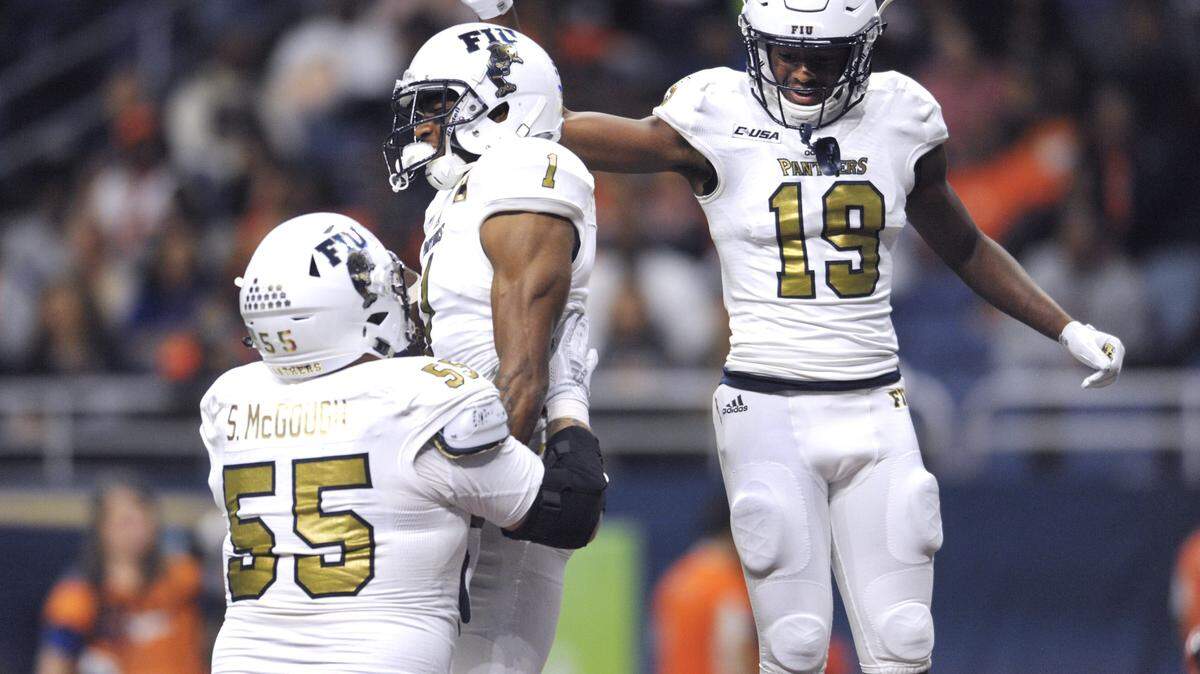 FIU receiver Maurice Alexander (1) celebrates with teammates Shane McGough (55) and Shemar Thornton (19) after catching a first-half touchdown against UTSA in the San Antonio Alamodome on Saturday, Nov. 10, 2018.