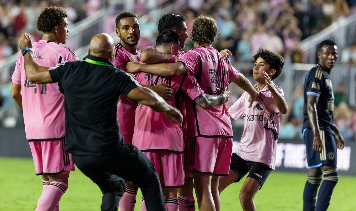 A field invader tries to celebrate with Inter Miami forward Lionel Messi (10) and his teammates after they scored a goal against the Philadelphia Union in the second half of their MLS match at Chase Stadium on Saturday, Sept. 14, 2024, in Fort Lauderdale, Fla.