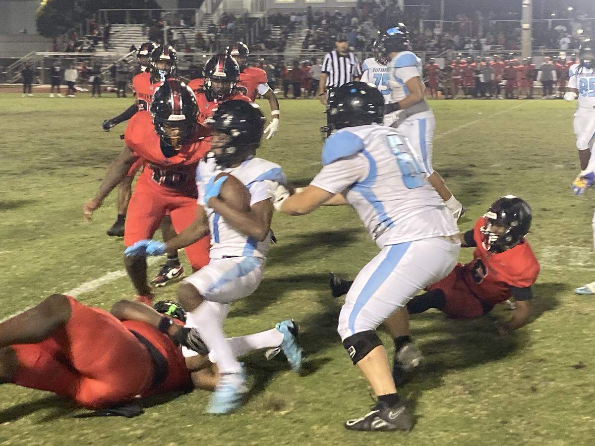 West Broward’s Amir Sears, who had a key 59-yard kickoff return late in the game, avoids Southridge defenders during this second quarter run in Friday’s Region 4-6A final at Southridge.