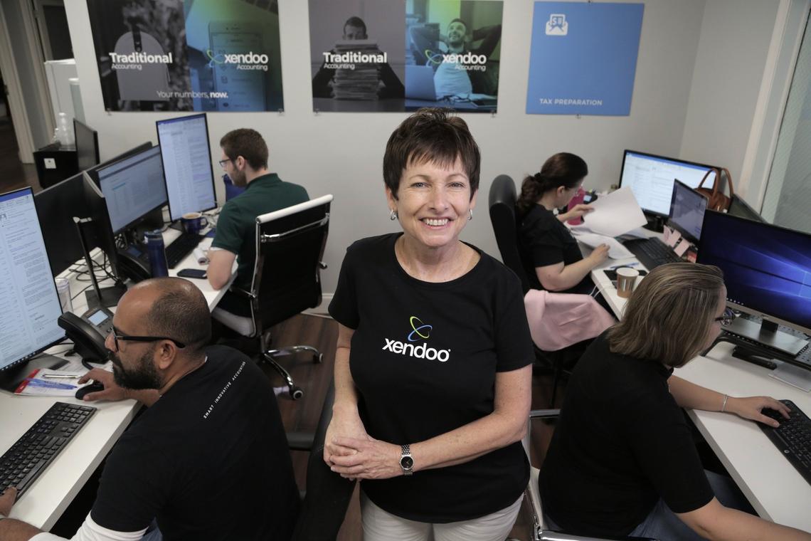 Fort Lauderdale, FL, June 26, 2019 - Lillian Roberts, Co-Founder of Xendoo (center) poses with busy employees in the office. Xendoo, is an online accounting and bookkeeping company located at 5300 Powerline Road, Ft. Lauderdale, Florida