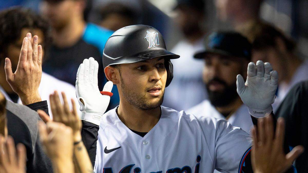 Miami Marlins base runner Alex Jackson (23) reacts with teammates in the Marlins dugout after hitting his first career home run during the second inning of an MLB game against the New York Mets at loanDepot park in the Little Havana neighborhood of Miami, Florida, on Tuesday, August 3, 2021.