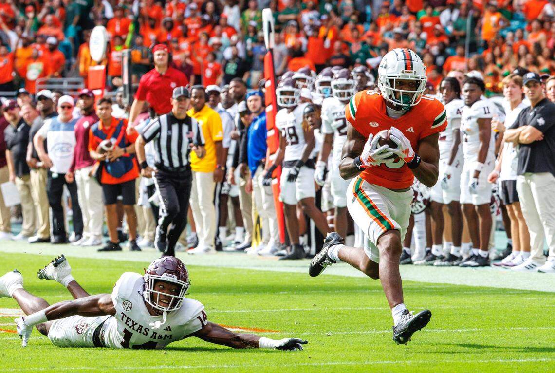 Miami Hurricanes wide receiver Isaiah Horton (16) runs after catching a pass as Texas A&M Aggies defensive back Jayvon Thomas (14) defends during the second quarter of an NCAA non conference game at Hard Rock Stadium on Saturday, Sept. 9, 2023 in Miami Gardens, Florida.