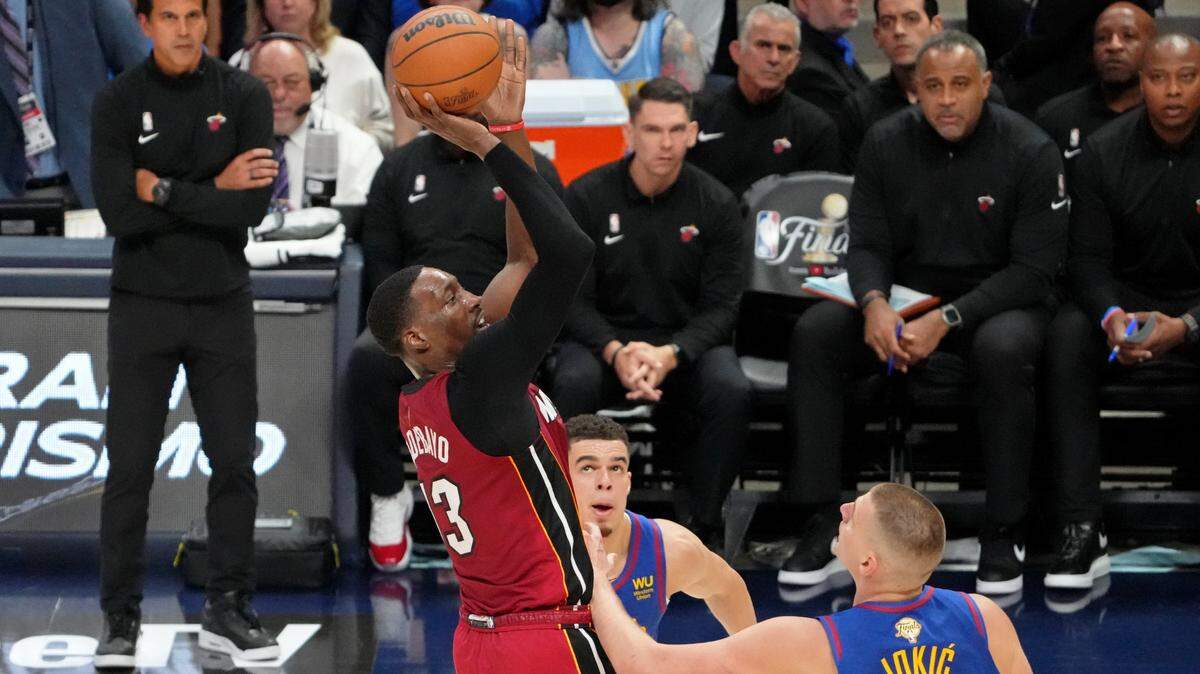 Miami Heat center Bam Adebayo (13) shoots the ball against Denver Nuggets center Nikola Jokic (15) during the second quarter in game one of the 2023 NBA Finals at Ball Arena.