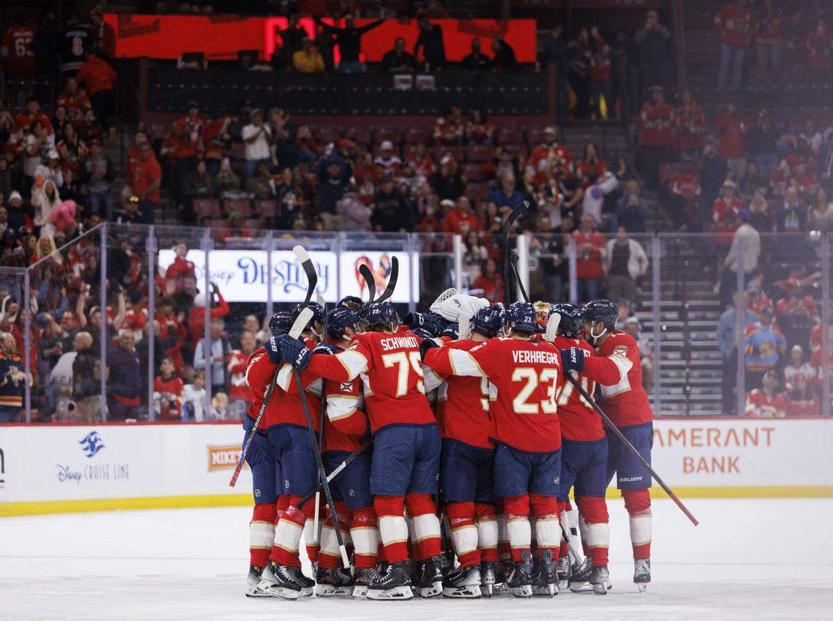 Florida Panthers left wing Brad Marchand (63) gets greeted by teammates on the ice after hitting 1000 career points during the third period of a game on Thursday, Nov. 13, 2025, at Amerant Bank Arena in Sunrise, Fla. The Florida Panthers won against the Washington Capitals 6-3.