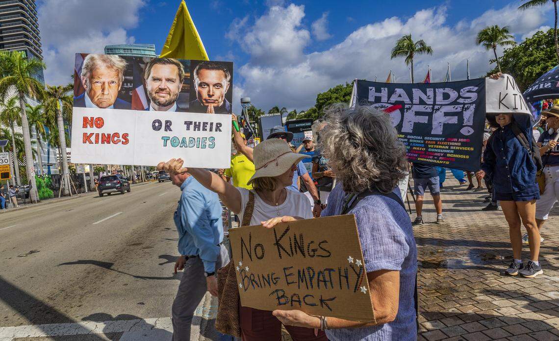 Protesters with signs at the Miami Torch of Friendship in downtown Miami during the ‘No Kings’ anti-Trump protests on Oct. 18, 2025.