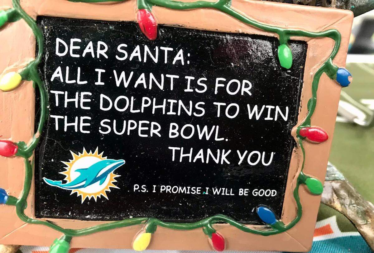 A message of holiday hope by a Dolphins tailgater at Hard Rock Stadium on Christmas Day.