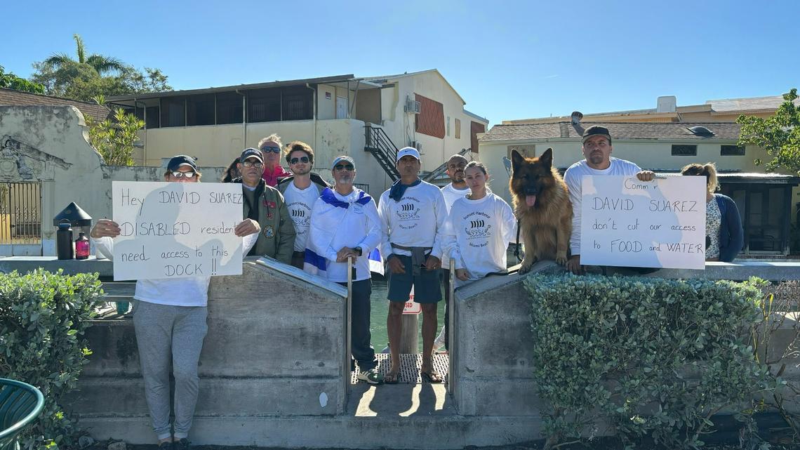 People who live on boats in Biscayne Bay protest a decision by Miami Beach officials to restrict access to a dock on Dade Boulevard near Michigan Avenue on Tuesday, Dec. 19, 2023. The boat dwellers say they rely on the dock for access to food and jobs on land.