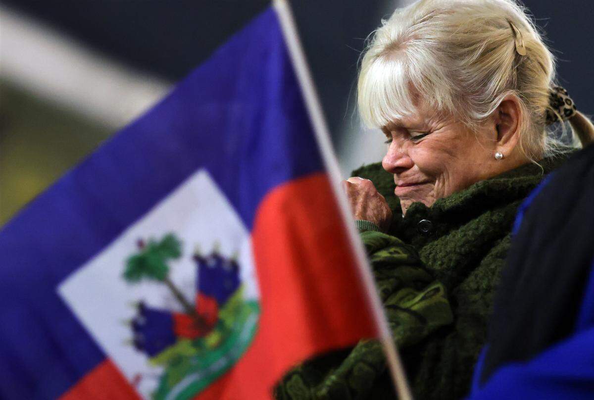Stephanie Rupp claps her hands in prayer at a candlelight prayer vigil at the Little Haiti Cultural Center on Feb. 3, 2026, in Miami. The event was held to show support for keeping Temporary Protected Status in place for Haitians in the U.S.
