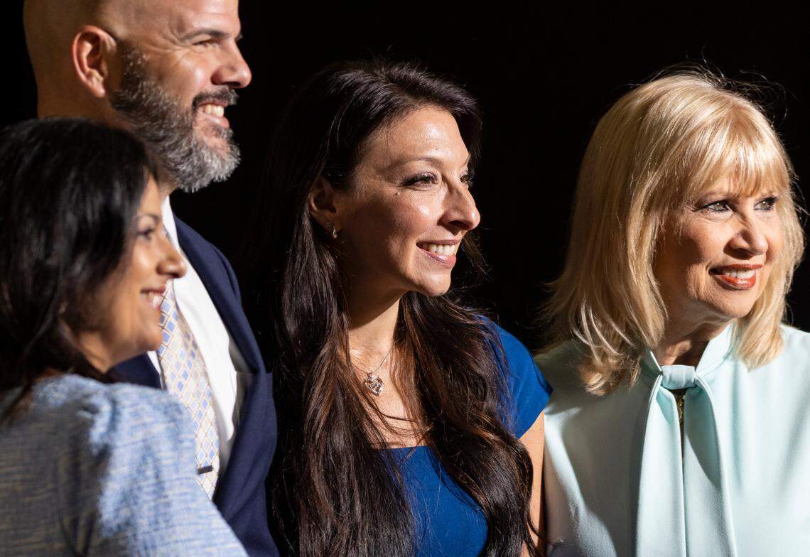From left to right: District 4 School Board Member Robert Alonso, Erika Donalds, founder of the Optima Foundation, and Miami-Dade School Board Chair Mari Tere Rojas attend a press conference with Florida Gov. Ron DeSantis at Christopher Columbus High School on Monday, March 27, 2023, in Miami, Fla. DeSantis signed HB1, which allows more Florida school children to become eligible for taxpayer-funded school vouchers. Critics of the law say it will divert funds from public schools.