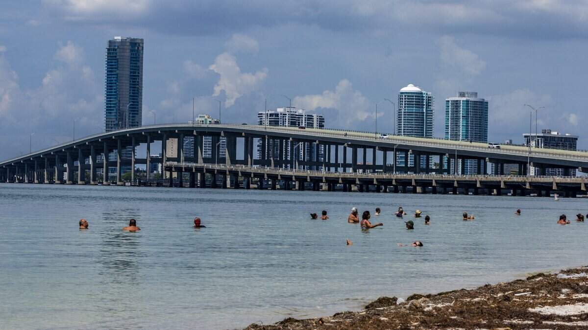 Beachgoers enjoy the nice weather at Hobie Island Beach as South Florida swelters under a heat advisory that warns of feels-like temperatures of 108, thoughts turn to the coming long Labor Day weekend in Miami , on Wednesday, August 27, 2025.