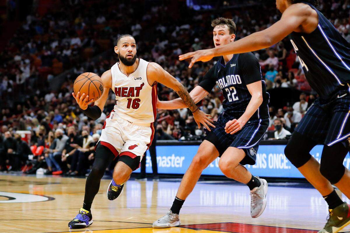 Miami Heat forward Caleb Martin (16) attempts to score against Orlando Magic forward Franz Wagner (22) during the third quarter of a game at FTX Arena in Miami on Sunday, December 26, 2021.