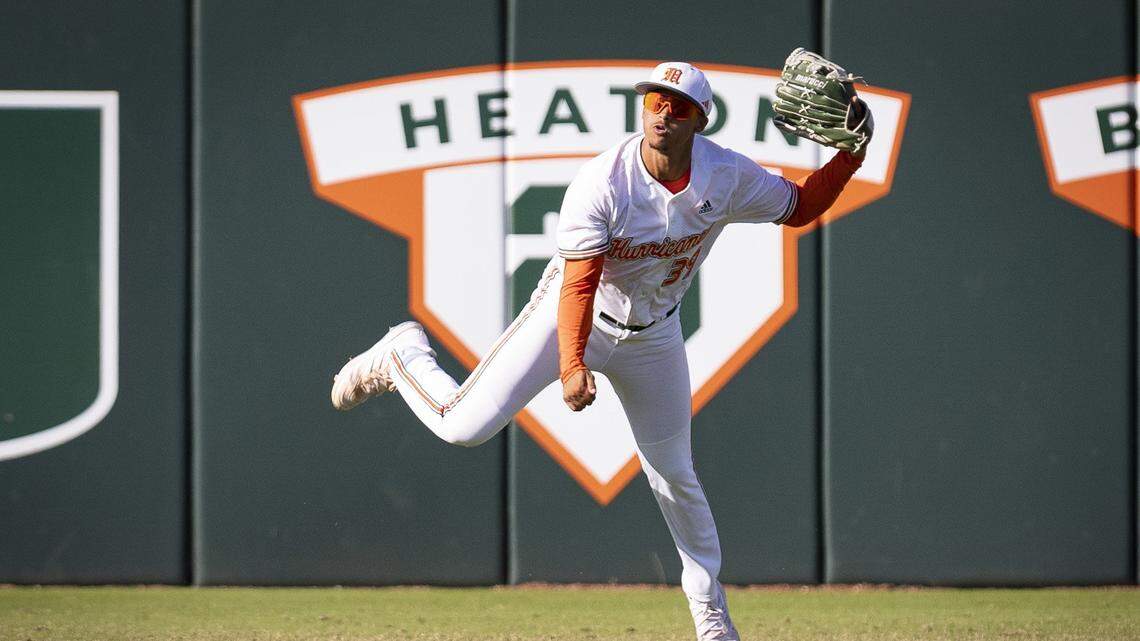 Miami Hurricanes outfielder Jacoby Long (39) jumps while throwing the ball to the infield during the ninth inning of a baseball game on Sunday, Feb. 25, 2024, at Alex Rodriguez Park in Coral Gables.