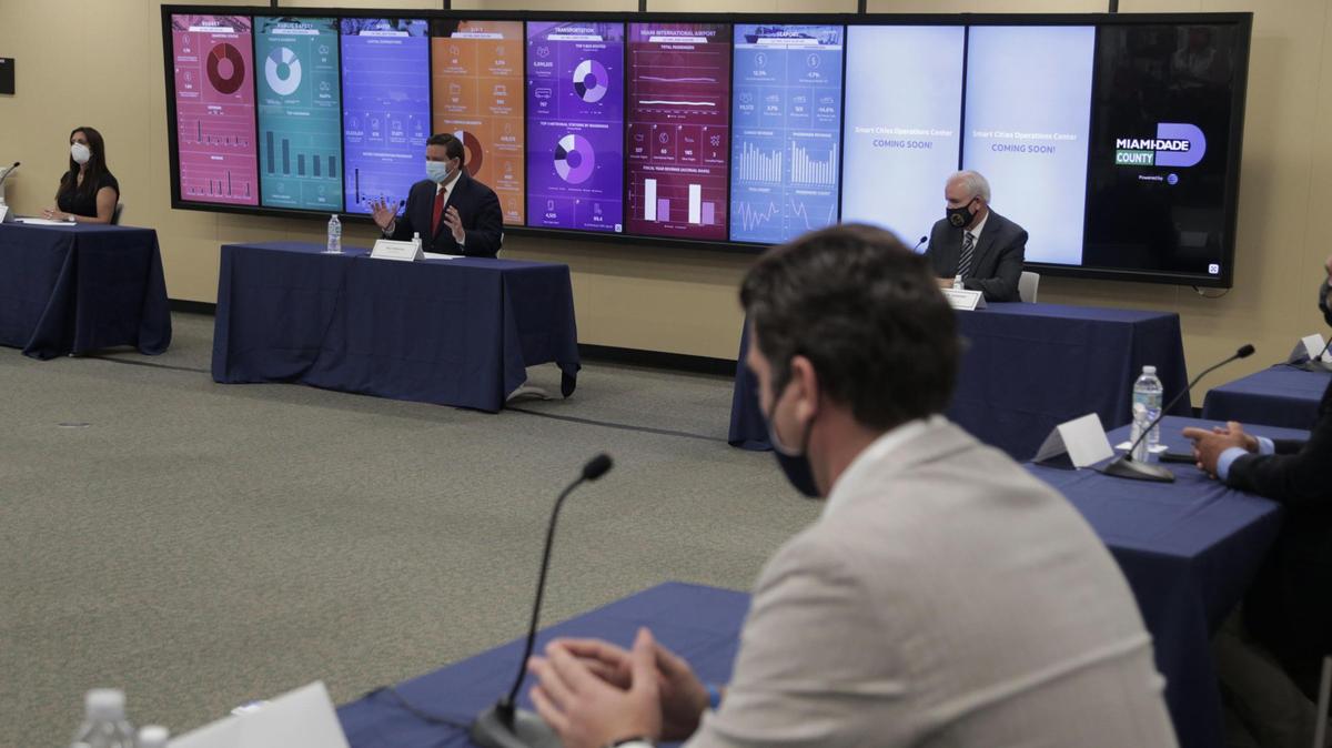 Florida Governor Ron DeSantis, second from left, speaks during a roundtable discussion with Miami-Dade County mayors regarding COVID-19 on Tuesday, July 14, 2020, at the Stephen P. Clark Government Center in Miami.
