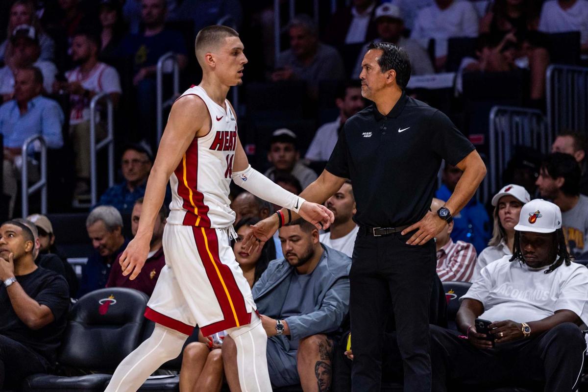Miami Heat guard Tyler Herro (14) walks towards the bench as he daps up Miami Heat Head Coach Erik Spoelstra during the first half of Game 4 of the Eastern Conference NBA Playoffs against the Cleveland Cavaliers at Kaseya Center on April 28, 2025, in Miami.