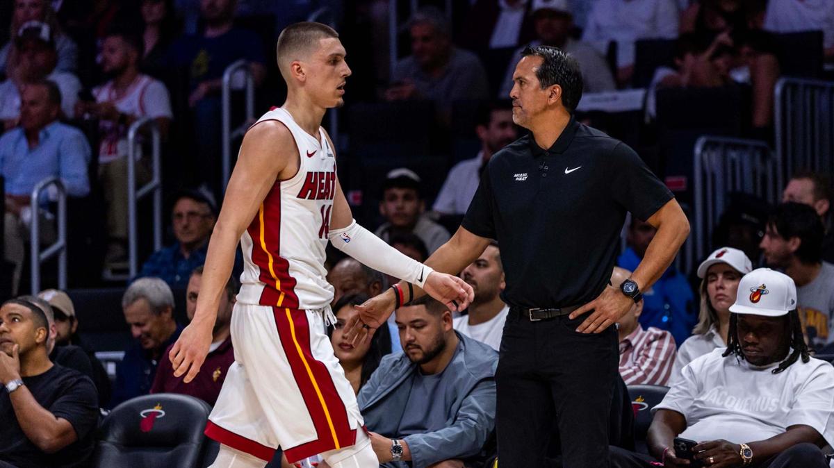 Miami Heat guard Tyler Herro (14) walks towards the bench as he daps up Miami Heat Head Coach Erik Spoelstra during the first half of Game 4 of the Eastern Conference NBA Playoffs against the Cleveland Cavaliers at Kaseya Center on April 28, 2025, in Miami.