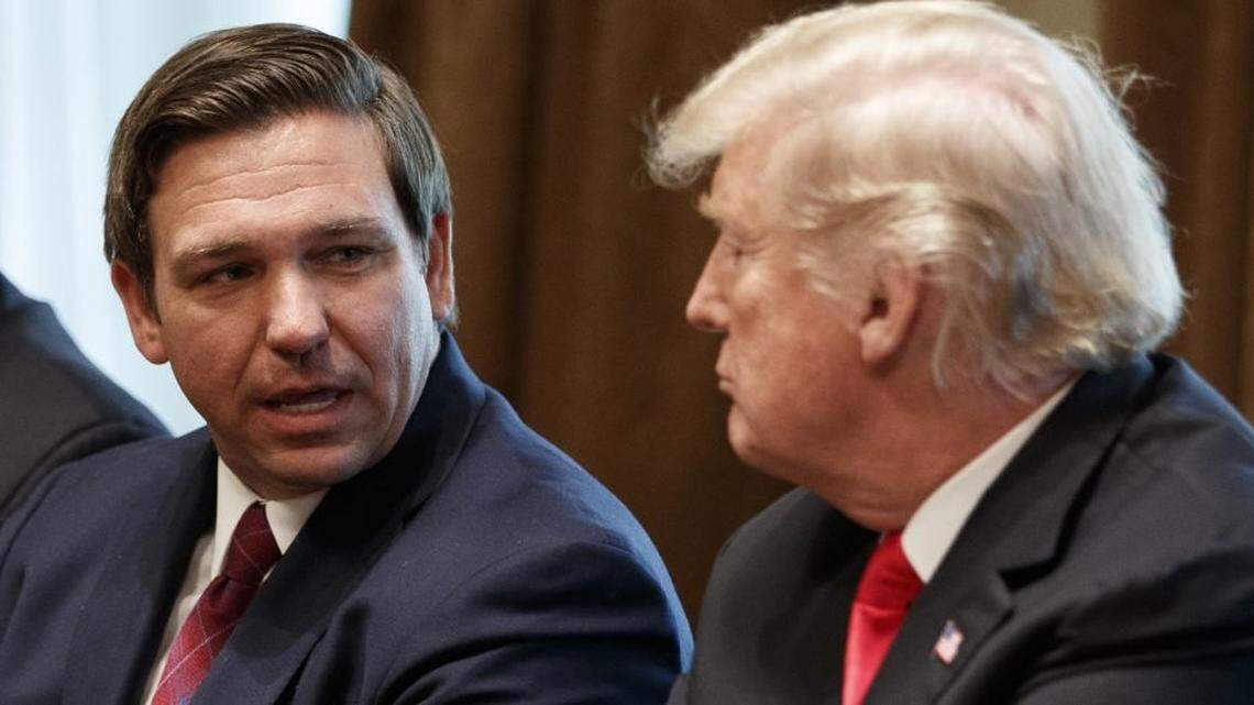 Florida Gov. Ron DeSantis talks with then-President Donald Trump during a meeting with newly elected governors at the White House in December 2018.
