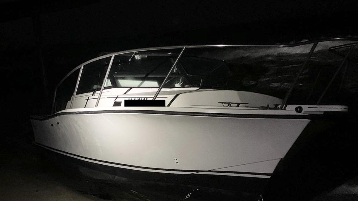A small cabin cruiser sits on the sands of Boynton Beach Friday morning, March 10, 2023. The U.S. Border Patrol says 10 people from five different countries were on the boat.
