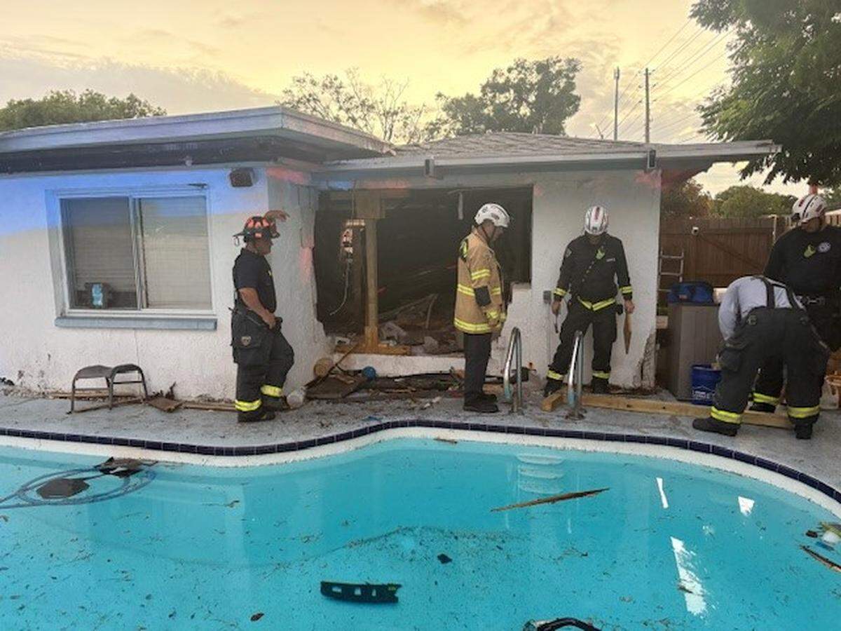 The SUV went airborne after it struck a pool in the home’s backyard, then crashed through a back wall, officials say.