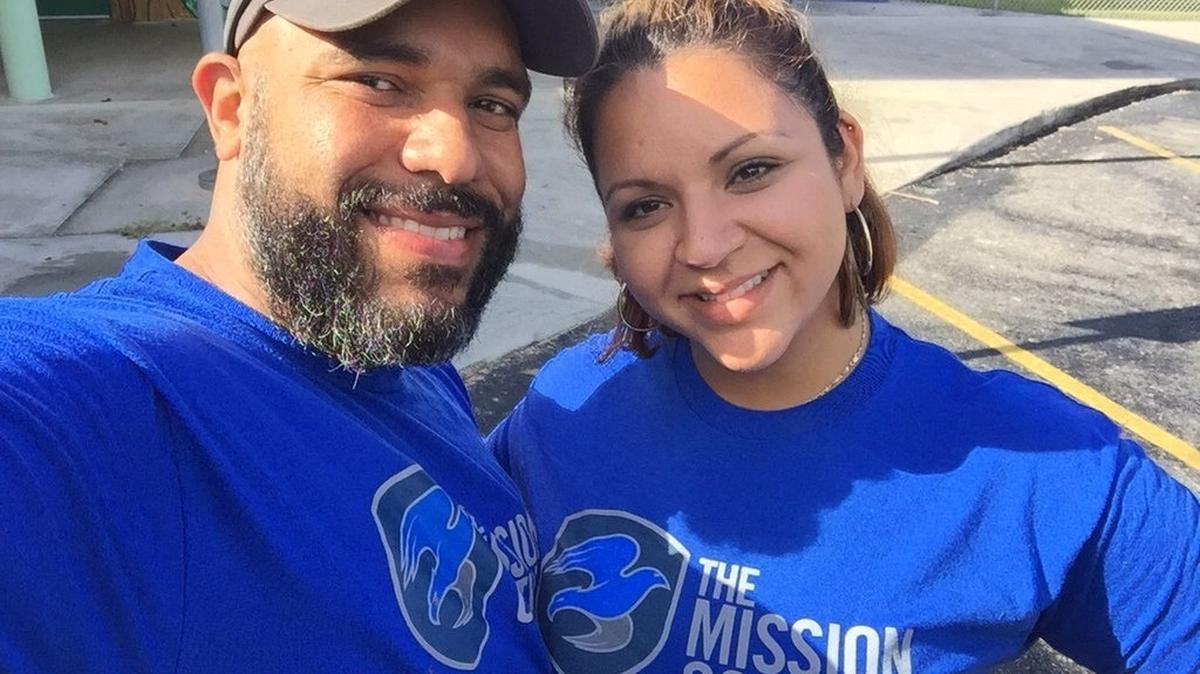 Derek Auguste and his wife, Kelly, wearing shirts from The Mission Continues, a nonprofit focused on helping veterans through community work.