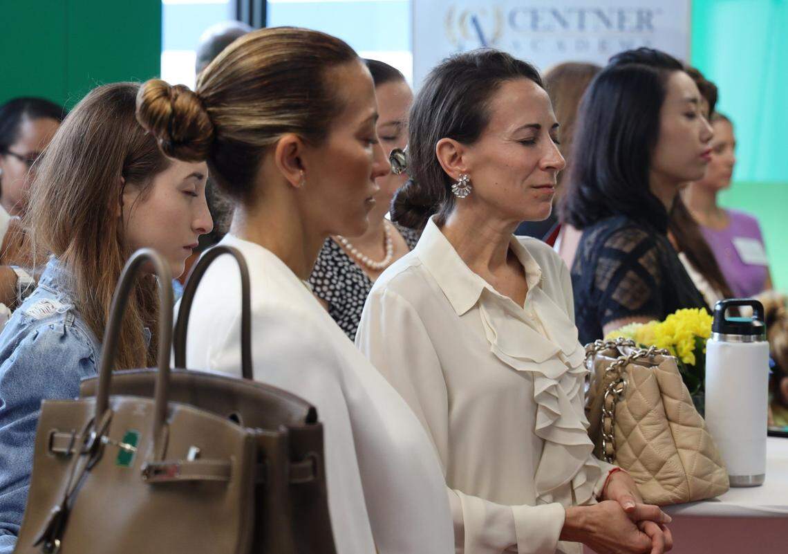 Alhia Molina, 21, Neila Granzoti Rudden, 40, and Bianca Erickson, 45, close their eyes in a moment of meditation during Centner Academy’s preview as Miami Design District school on Aug 21, 2019.
