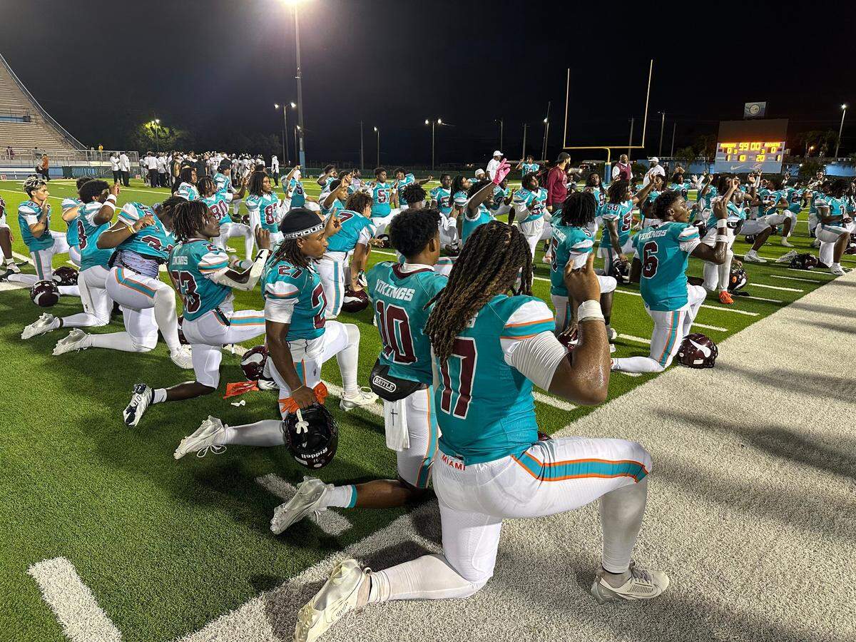 Miami Norland’s players, clad in Miami Dolphins-themed uniforms, celebrate their 32-27 victory over Plantation American Heritage on Monday night at Traz Powell Stadium.