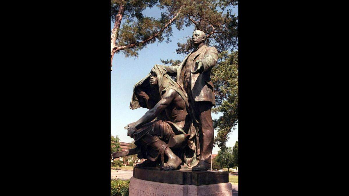 Statue of Booker T. Washington, lifting the veil of slavery, on the grounds of the Tuskegee Institute National Historic Site.