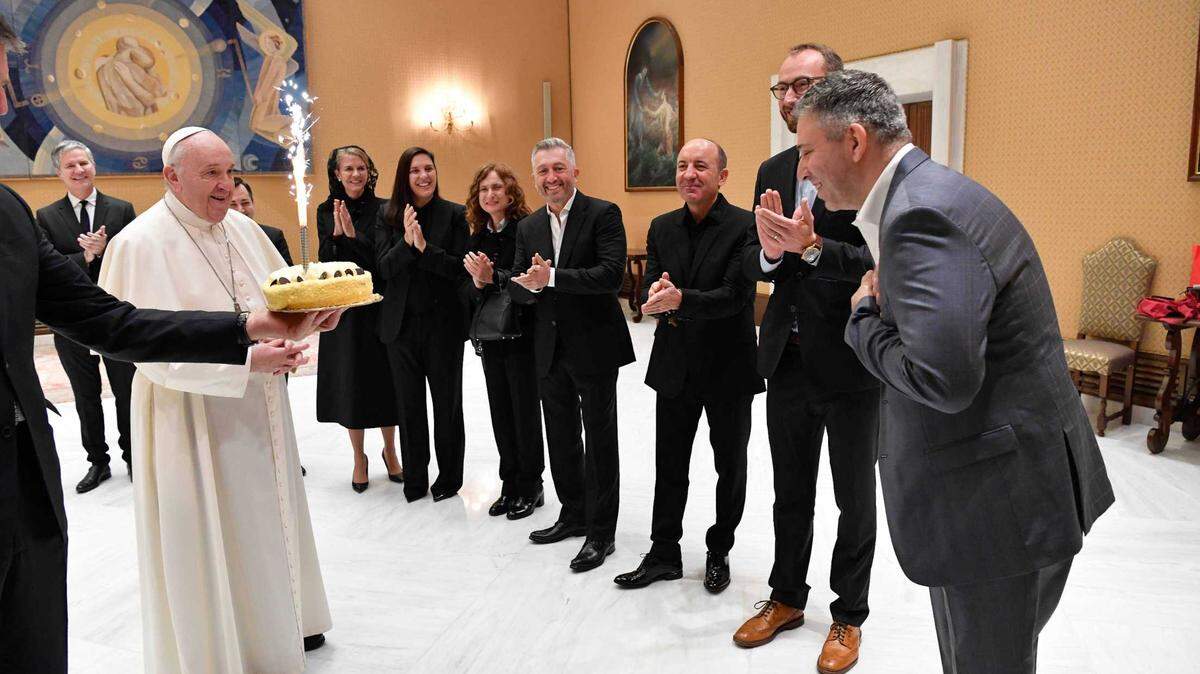 Pope Francis presents a birthday cake to ‘Francesco’ filmmaker Evgeny Afineevsky following the film’s premiere Oct. 21 at the Rome Film Festival.