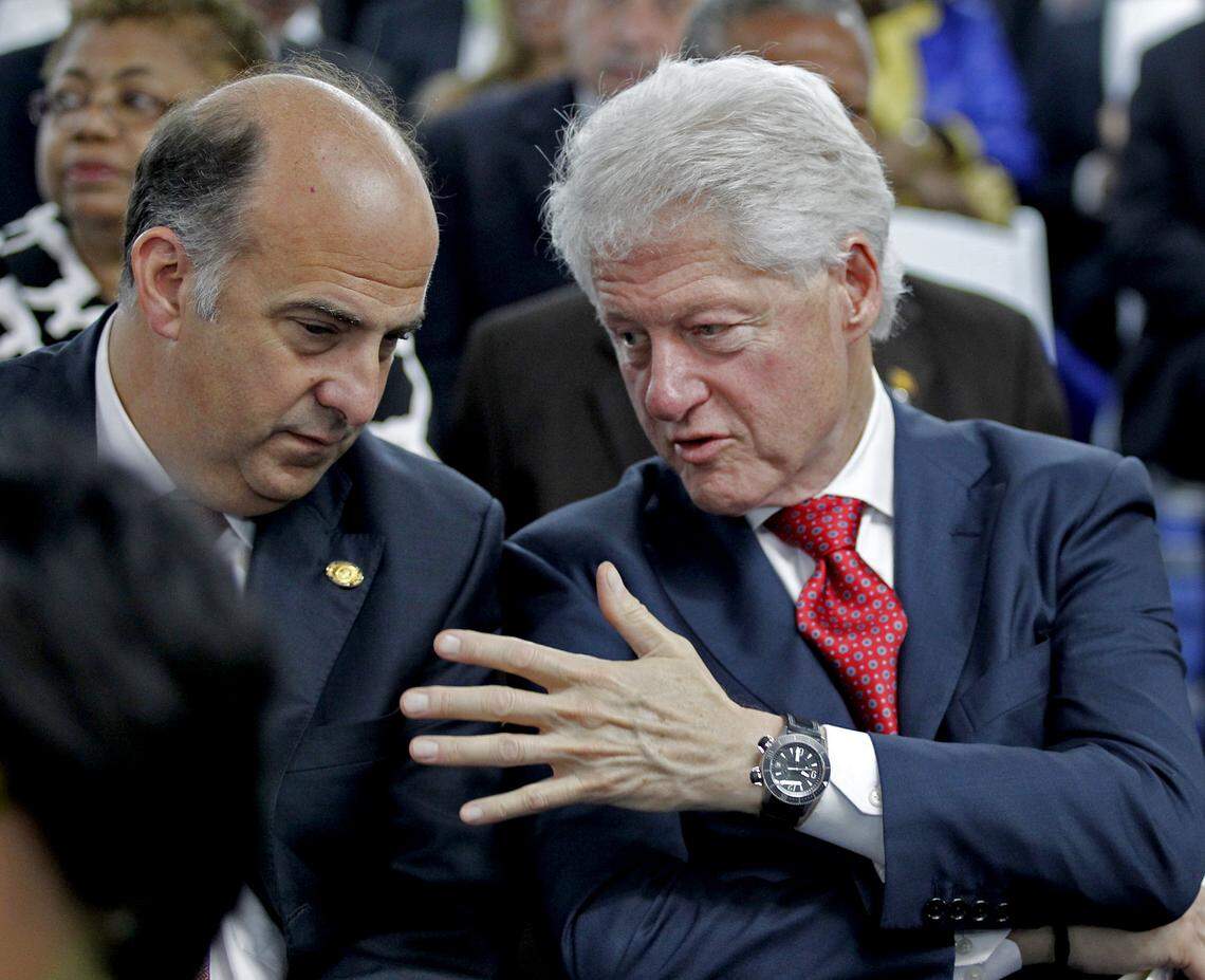 U.S. Ambassador Kenneth Merten, left, and former President Bill Clinton share a conversation prior to the swearing-in of Michel Martelly as Haiti’s 56th president inside the Parliament building on May 14, 2011, in Port-au-Prince.