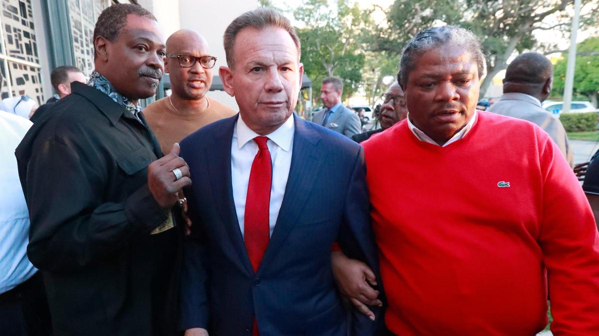 Suspended Broward County Sheriff Scott Israel, center, leaves a news conference surrounded by supporters Friday, Jan. 11, 2019, in Fort Lauderdale, Fla., after new Florida Gov. Ron DeSantis suspended him, over his handling of last February’s massacre at Marjory Stoneman Douglas High School.