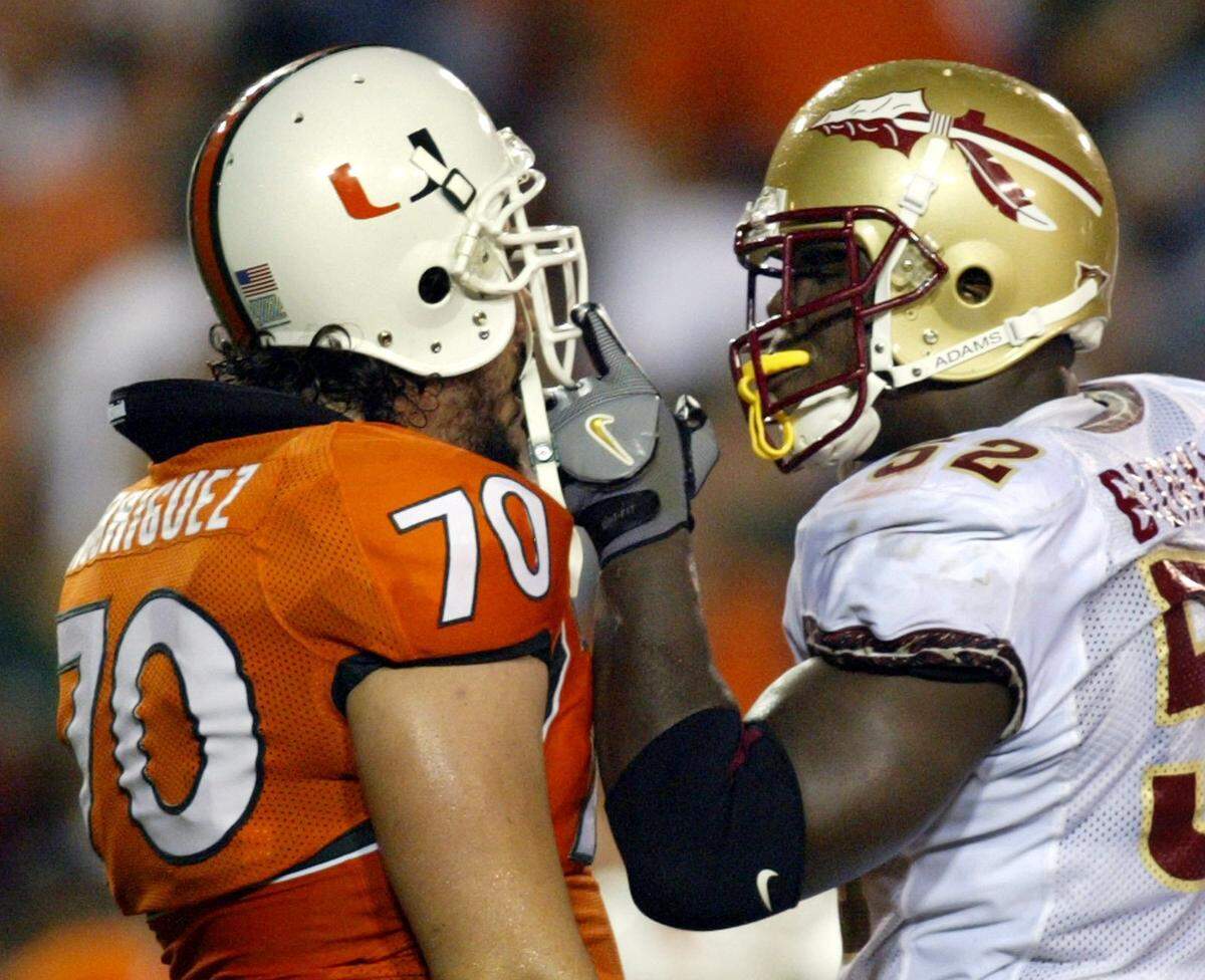 In 2004, FSU’s Brodrick Bunkley sticks his finger in the face of UM’s Joel Rodriguez during the first half of a game at the Orange Bowl.