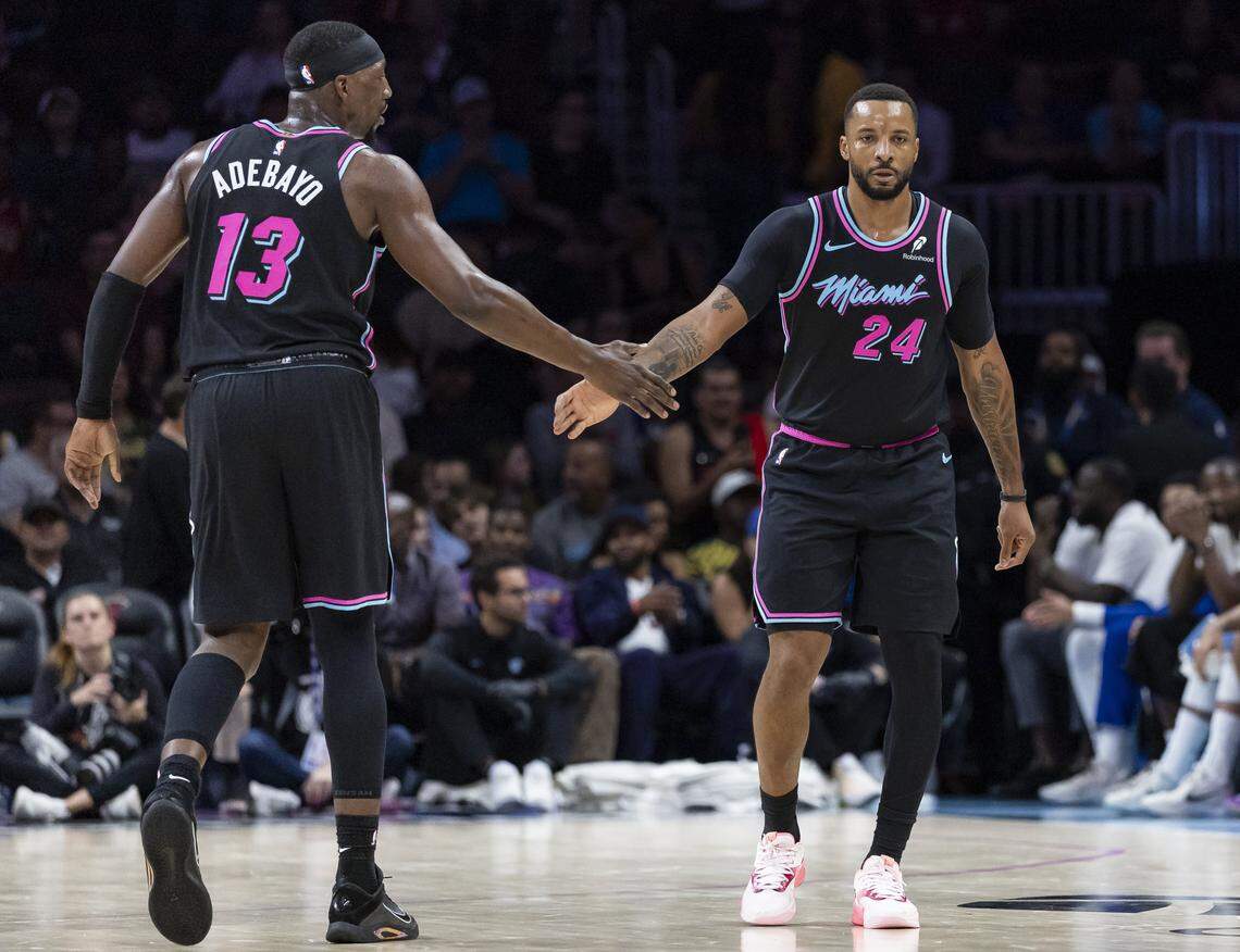 Miami Heat center Bam Adebayo (13) and guard Norman Powell (24) celebrate after scoring against the Golden State Warriors in the second half of their NBA game at Kaseya Center on Nov. 19, 2025, in Miami.