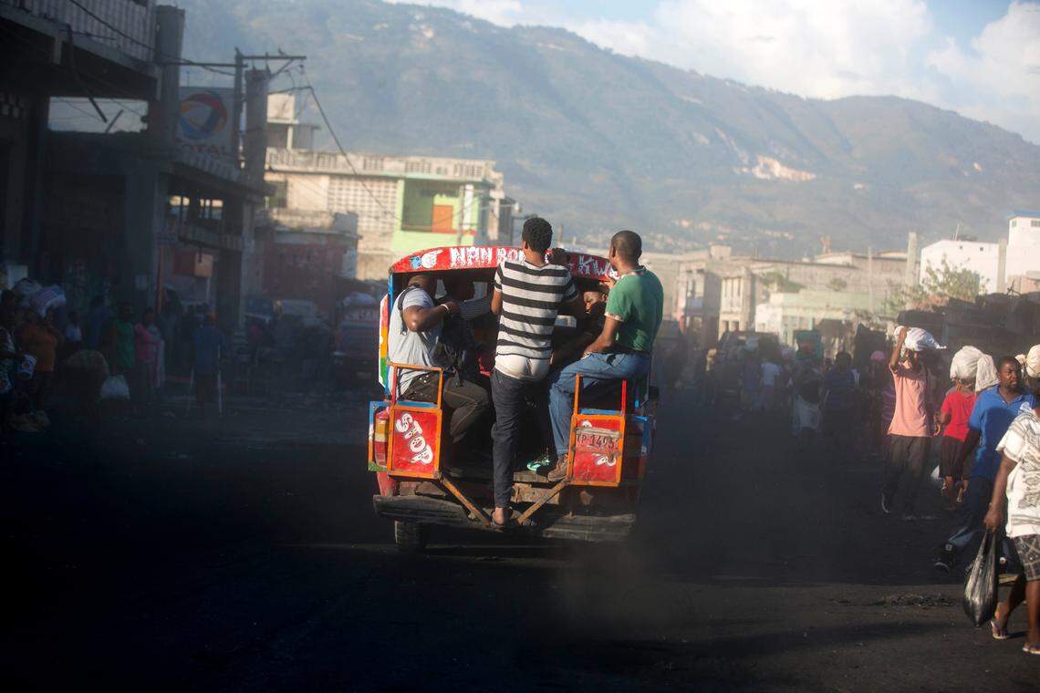A tap-tap bus carries commuters on the second day of a national general strike in Port-au-Prince, Haiti, early Tuesday, July 10, 2018.