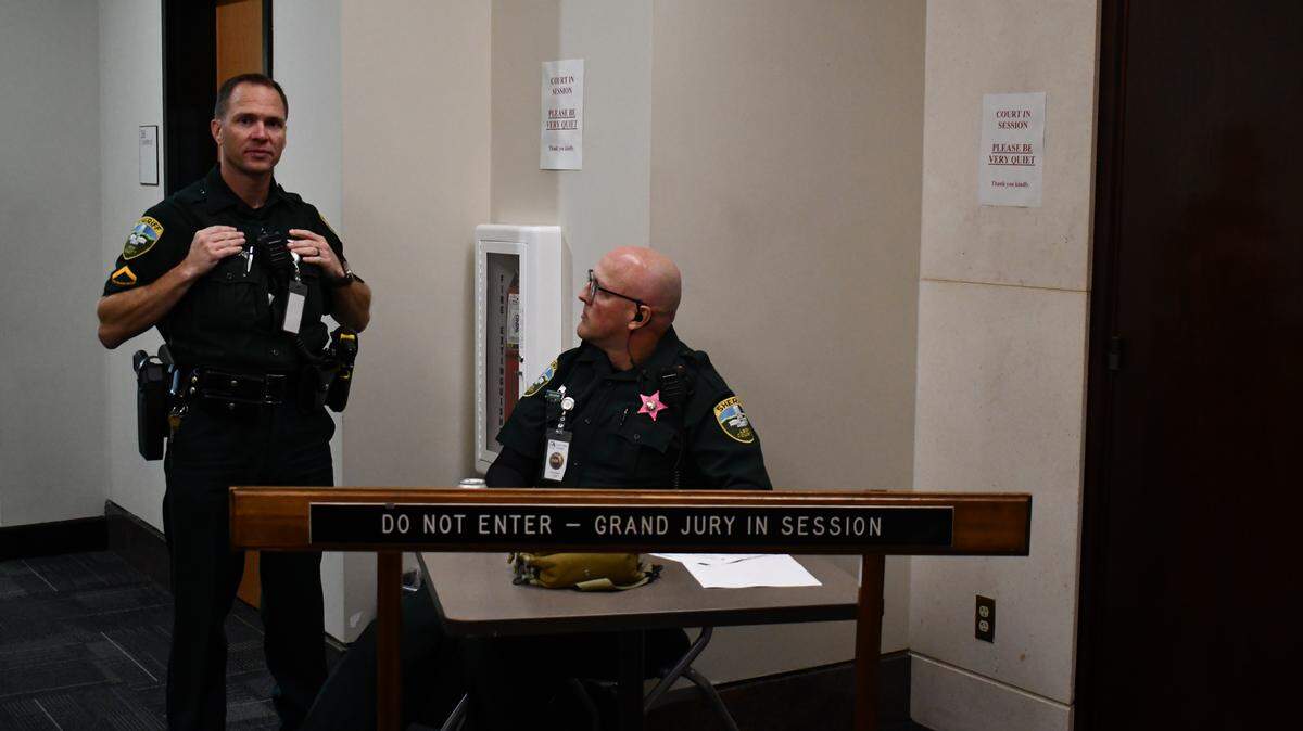 Two Leon County Sheriff’s Deputies guard the entrance to the courtroom where witnesses are testifying before a grand jury in the investigation related to Hope Florida.
